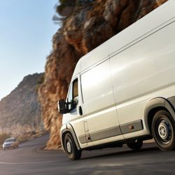 Blaze Express Courier Service - White van on the road going to make deliveries
