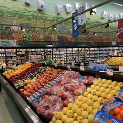 Exceptional displays of fresh fruits and vegetables, highlighted by the bright, colorful, murals on the walls!