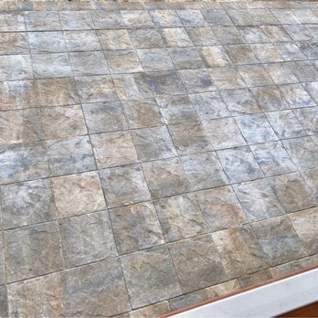 J Imagine Landscaping - a patio with a tile floor - Patio Coverings Near Me