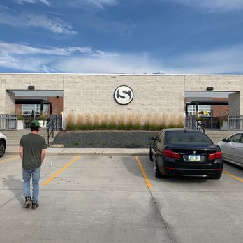 Smash Park - a man standing in a parking lot - Bars Near Me - West Des Moines, Iowa Smash Park - a man standing in a parking lot - Bars Near Me - West Des Moines, Iowa