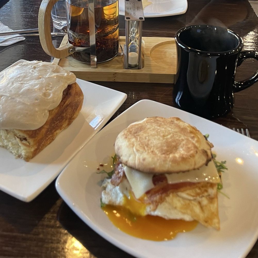Chili crisp egg sandwich, cinnamon roll, and tea. Chili crisp egg sandwich, cinnamon roll, and tea.