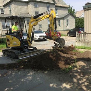 Guilmette Landworks - an excavator working on a residential street - Excavation Services Near Me - Burlington, Vermont