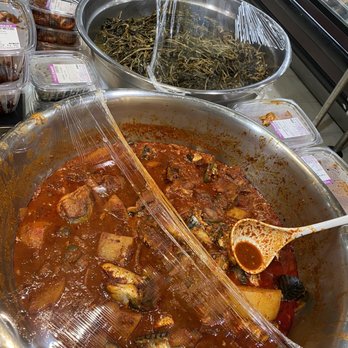 Super H Mart - a pan of stew with a wooden spoon - Grocery Near Me - Tucker, Georgia