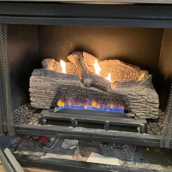 Sixpenny Chimney Sweeps - Vented gas logs burning over a blue-flame burner with a ceramic log set inside a home fireplace, installed and serviced by Si... - Chimney Sweeps Near Me - Woodbridge, Virginia Sixpenny Chimney Sweeps - Vented gas logs burning over a blue-flame burner with a ceramic log set inside a home fireplace, installed and serviced by Si... - Chimney Sweeps Near Me - Woodbridge, Virginia