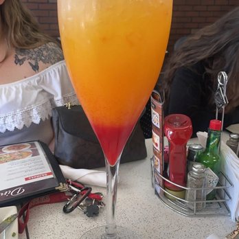 Courtyard Mimosas - Giant strawberry/mango mimosa- served in a frosty mug for 5 people to share and we all had 3 servings each. We loved it! - American Near Me - Los Banos, California Courtyard Mimosas - Giant strawberry/mango mimosa- served in a frosty mug for 5 people to share and we all had 3 servings each. We loved it! - American Near Me - Los Banos, California