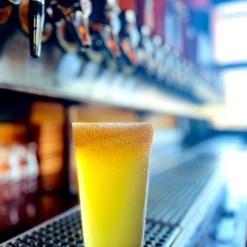 Growler's Taphouse - a glass of beer on a bar - Sports Bars Near Me - Tucson, Arizona Growler's Taphouse - a glass of beer on a bar - Sports Bars Near Me - Tucson, Arizona
