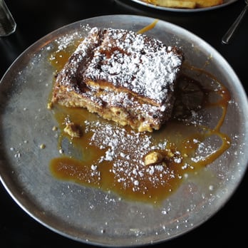 Oy! - Decadent Challah French Toast Casserole ($11.97). Warm challah French toast, warm syrup, buttery caramel sauce, powdered sugar. - Breakfast & Brunch Near Me - Atlanta, Georgia Oy! - Decadent Challah French Toast Casserole ($11.97). Warm challah French toast, warm syrup, buttery caramel sauce, powdered sugar. - Breakfast & Brunch Near Me - Atlanta, Georgia