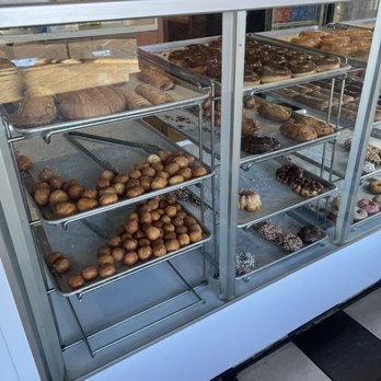 Hooz Donuts - a display case filled with donuts - Donuts Near Me - San Jose, California