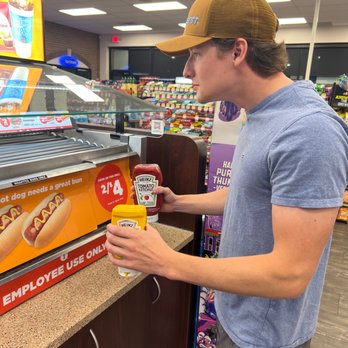Circle K - a man standing in a grocery store - Pizza Near Me - Battle Creek, Michigan