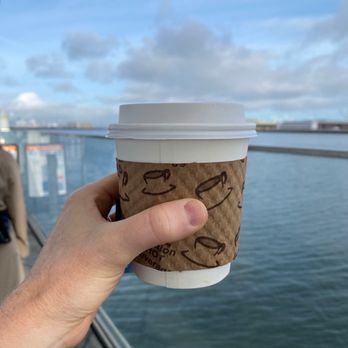 Get Goes Mobile Cafe - a hand holding a coffee cup - Coffee & Tea Near Me