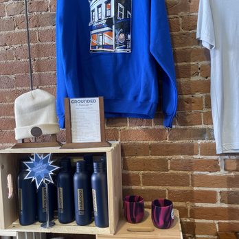 Grounded Patio Cafe - a blue sweatshirt hanging on a brick wall - Coffee & Tea Near Me - La Crosse, Wisconsin