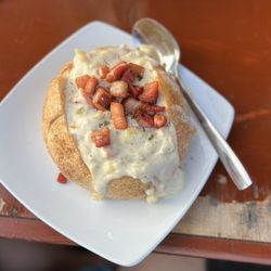 Playa Hermosa Fish & Oyster - Clam chowder sourdough bowl with pork belly on top.