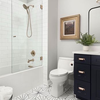 B & A Homes Remodel - a white bathroom with a black vanity and toilet - Painters Near Me