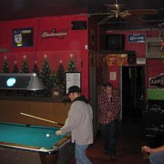 Photo of Dave's Tavern - San Diego, CA, United States. Dave's Tavern pool table....sign up on the white board in the background. It was a rare karaoke night....Kevin is singing!