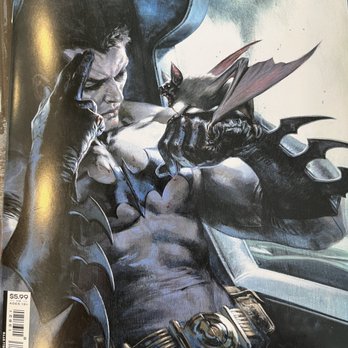 Multiverse - Love this cover - The image depicts a detailed illustration of Batman seated inside a vehicle, with a bat-like creature perched on his hand. Batman's expression is serious, and he is wearing his iconic costume with a bat emblem on his chest. The illustration uses dark tones and shading to emphasize a moody atmosphere. The vehicle's interior is partially visible, and the artwork appears to be a comic book or poster style. A price tag indicating $5.99 and age recommendation of 13+ is visible in the lower left corner. - Bookstores Near Me - Philadelphia, Pennsylvania