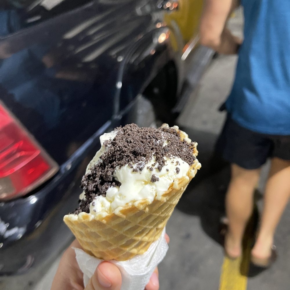 cookie dough double scoop in a giant waffle cone with oreo crumbs