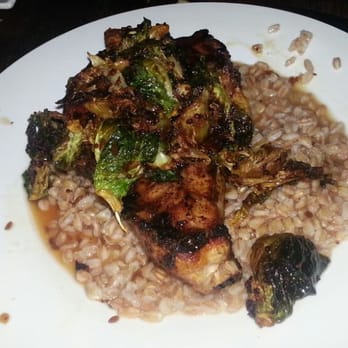Flying Pig Pub & Kitchen - Porkchop topped w roasted brussel sprouts laying on a bed of barley - Pubs Near Me - Oceanside, California Flying Pig Pub & Kitchen - Porkchop topped w roasted brussel sprouts laying on a bed of barley - Pubs Near Me - Oceanside, California
