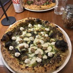 pesto pizza with sausage and ricotta