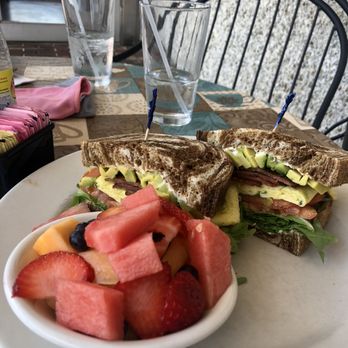Daphne's Dining & Catering - Momma D's Signature Breakfast Sandwich: egg, avocado, Brie spread, bacon, and arugula on pumpernickel bread with a side of fresh fruit. - American Near Me - Robbinsville, New Jersey Daphne's Dining & Catering - Momma D's Signature Breakfast Sandwich: egg, avocado, Brie spread, bacon, and arugula on pumpernickel bread with a side of fresh fruit. - American Near Me - Robbinsville, New Jersey