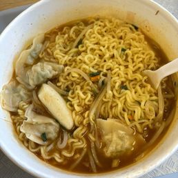shin ramen with beef dumplings, rice cakes and bean sprouts