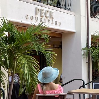 Peck Courtyard - a woman sitting in a chair in front of a building - Music Venues Near Me - Fort Lauderdale, Florida Peck Courtyard - a woman sitting in a chair in front of a building - Music Venues Near Me - Fort Lauderdale, Florida