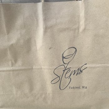 Stems - a person holding a brown paper bag - Beer, Wine & Spirits Near Me - Yakima, Washington