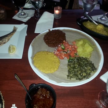Ethiopic - Veggie Sampler in the middle, Doro Wat on the right. At the bottom is the spicy beef wat and clearly the fish on the left. - Ethiopian Near Me - Washington, DC, District of Columbia Ethiopic - Veggie Sampler in the middle, Doro Wat on the right. At the bottom is the spicy beef wat and clearly the fish on the left. - Ethiopian Near Me - Washington, DC, District of Columbia