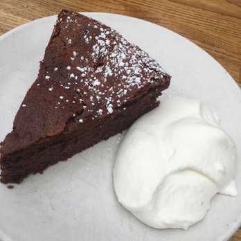 Pizzetta 211 - Flourless Valrhona Chocolate Cake (Almond bits) and Sweetened Whipped Cream (Fudgy Goodness). - Pizza Near Me - San Francisco, California Pizzetta 211 - Flourless Valrhona Chocolate Cake (Almond bits) and Sweetened Whipped Cream (Fudgy Goodness). - Pizza Near Me - San Francisco, California