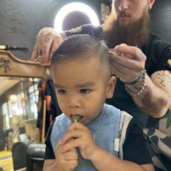 Gold Line Barber Shop - Tanner hooking my son's hair up while he drools all over me.  it's the only time he gets a lollipop.