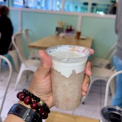 Ig@BlackTigerEats holding taro and cream dessert