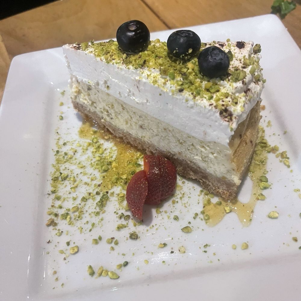 Rosine's Mediterranean Cafe - Rich and creamy pistachio cheesecake,perfectly indulgent and irresistible! - Mediterranean Near Me - Anaheim, California Rosine's Mediterranean Cafe - Rich and creamy pistachio cheesecake,perfectly indulgent and irresistible! - Mediterranean Near Me - Anaheim, California