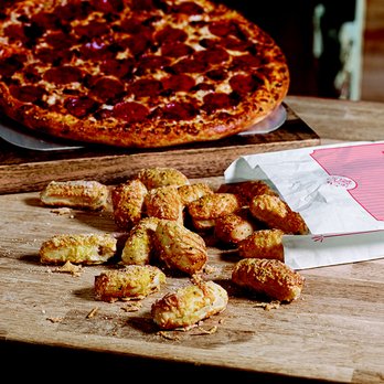 Domino's - a pizza and chicken wings on a cutting board - Pizza Near Me - Newton, North Carolina Domino's - a pizza and chicken wings on a cutting board - Pizza Near Me - Newton, North Carolina