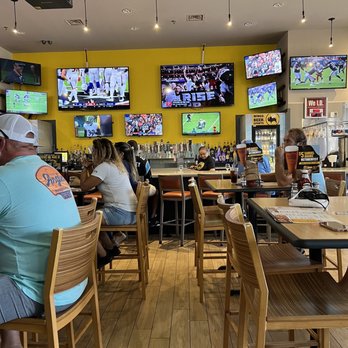 Buffalo Wild Wings - people sitting at tables watching televisions - Chicken Wings Near Me - Tomball, Texas Buffalo Wild Wings - people sitting at tables watching televisions - Chicken Wings Near Me - Tomball, Texas