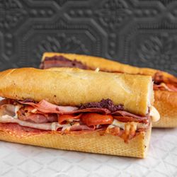 Spuntini Street Eats - ANTIPASTO SANDWICH

Salami, Pepperoni, Prosciutto, Mortadella, Olives, Pasta Sauce, Mozzarella on a Toasted Garlic Bread Loaf