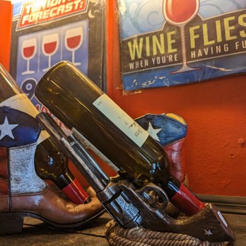 Hill Country Wine Shoppe - a pair of cowboy boots and a bottle of wine - Wineries Near Me - Wimberley, Texas Hill Country Wine Shoppe - a pair of cowboy boots and a bottle of wine - Wineries Near Me - Wimberley, Texas