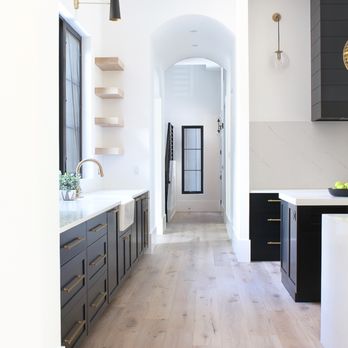DAL Builders - a kitchen with black cabinets and white countertops - General Contractors Near Me - Oakbrook Terrace, Illinois