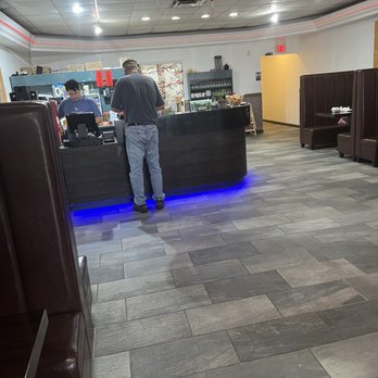 Hunan Bistro - a man standing at a counter in a restaurant - Chinese Near Me - Middletown, Ohio