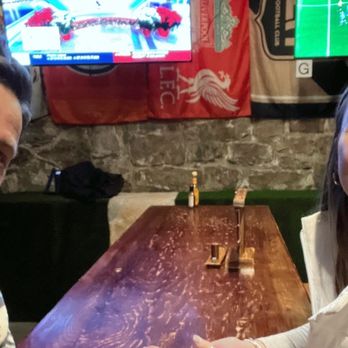 Liga -  two people sitting at a table - Sports Bars Near Me - Boise, Idaho