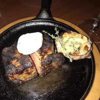 A Restaurant - Amazing 12 oz New York steak cut in half for my wife and into share. Cooked medium which was just perfect in every way. - New American Near Me - Newport Beach, California