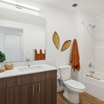 The Mill on Maple Apartments - a bathroom with a toilet sink and shower and a mirror at The Mill on Maple Apartments, Oregon, 97045 - Apartments Near Me - Oregon City, Oregon The Mill on Maple Apartments - a bathroom with a toilet sink and shower and a mirror at The Mill on Maple Apartments, Oregon, 97045 - Apartments Near Me - Oregon City, Oregon