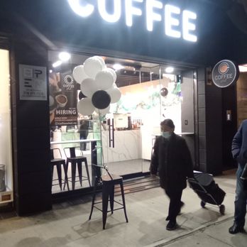 Coffee Shot - a man walking down the sidewalk - Coffee & Tea Near Me - Forest Hills, New York