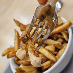 Crystal Spring Grocery - Close-up of a fork holding the fries with special sauce.