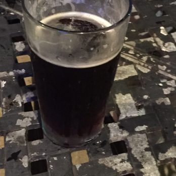 Murphy's Law - a glass of beer on a table - Irish Pub Near Me - Bryan, Texas