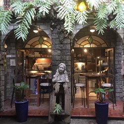 La Bodega Wine + Tapas - My favorite place to sit is at one of the high top tables under the pretty arches framed with real ferns.