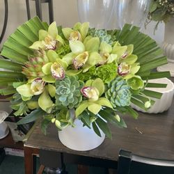 All About Flowers - Green cymbidium Orchids and succulents arranged artfully in a ceramic white container