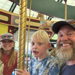 Carousel riding kids and Dad