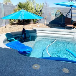 a pool with a slide and umbrellas a pool with a slide and umbrellas
