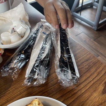 Denny's - a person holding a knife and a slice of bread - American Near Me - Apple Valley, Minnesota