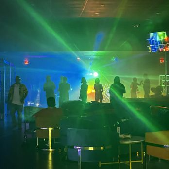 FUMA Lounge - a crowd of people standing around a bar - Cigar Bars Near Me - Kissimmee, Florida