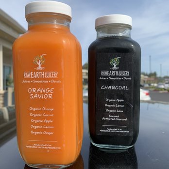 Raw Earth Juicery - two bottles of orange and black juice - Juice Bars & Smoothies Near Me - Fresno, California Raw Earth Juicery - two bottles of orange and black juice - Juice Bars & Smoothies Near Me - Fresno, California